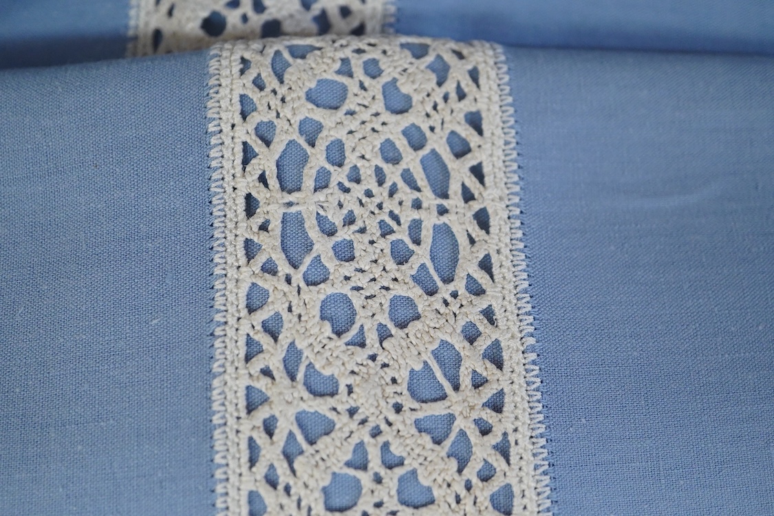 Thirteen mixed French mostly coloured provincial linen sheets some embroidered with monograms, floral embroidery, or decorated with crochet.